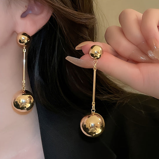 Elegant And Simple Golden Commuter Earrings With Round Tassels