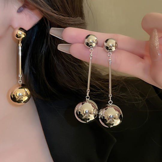 Elegant And Simple Golden Commuter Earrings With Round Tassels